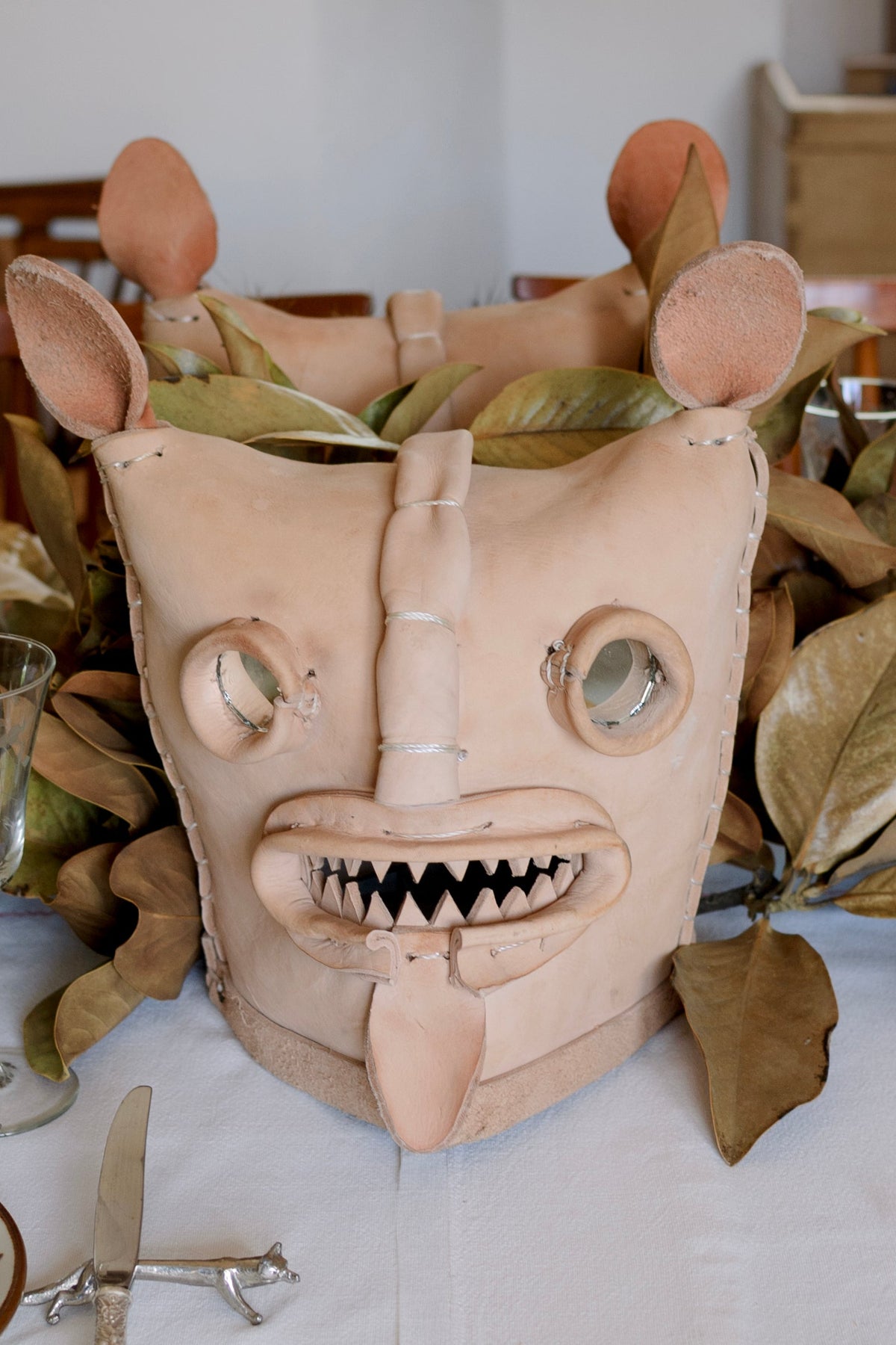 Zitlala Leather Tecuani Mask featuring detailed craftsmanship and intricate design, displayed on a neutral background.