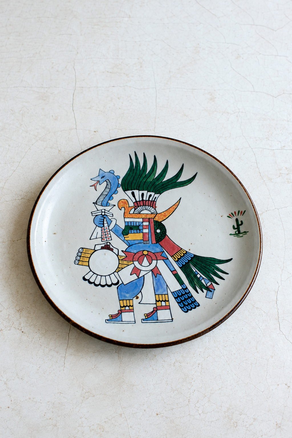 Folk art warrior figure plate from El Palomar, crafted by Embajada Craft, featuring pre-Hispanic style on crackled ceramic tableware.