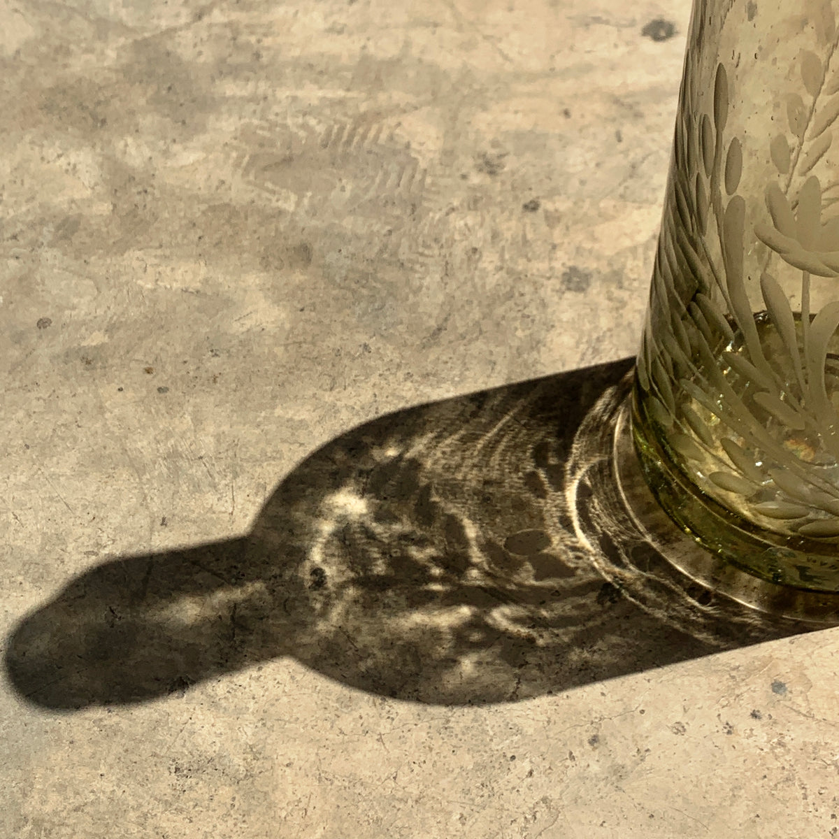 Hand blown glass bottle with Pepita engraving, decorative home decor piece by Embajada Craft featuring intricate glasswork.