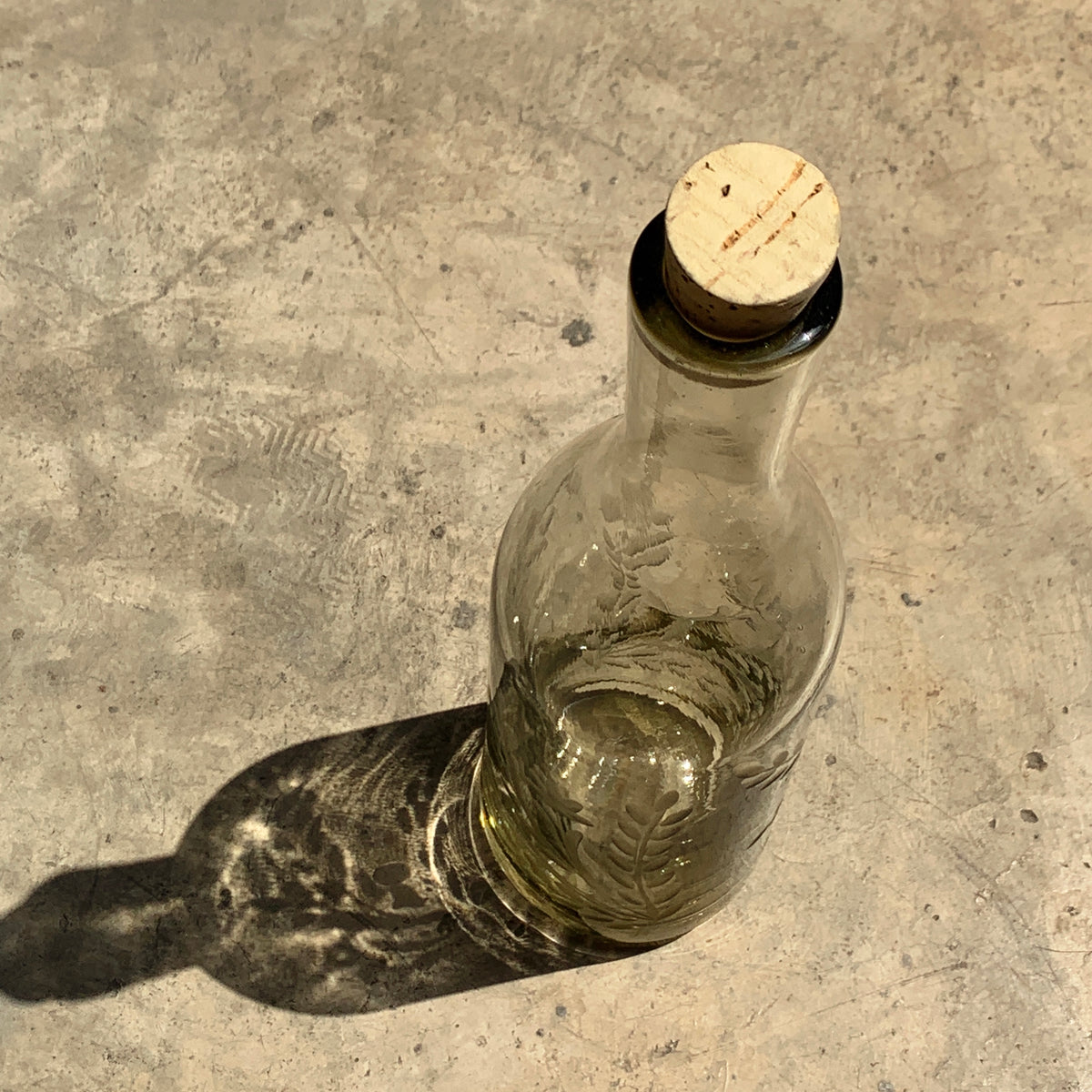 Hand blown glass bottle with Pepita engraving, decorative home decor piece by Embajada Craft.