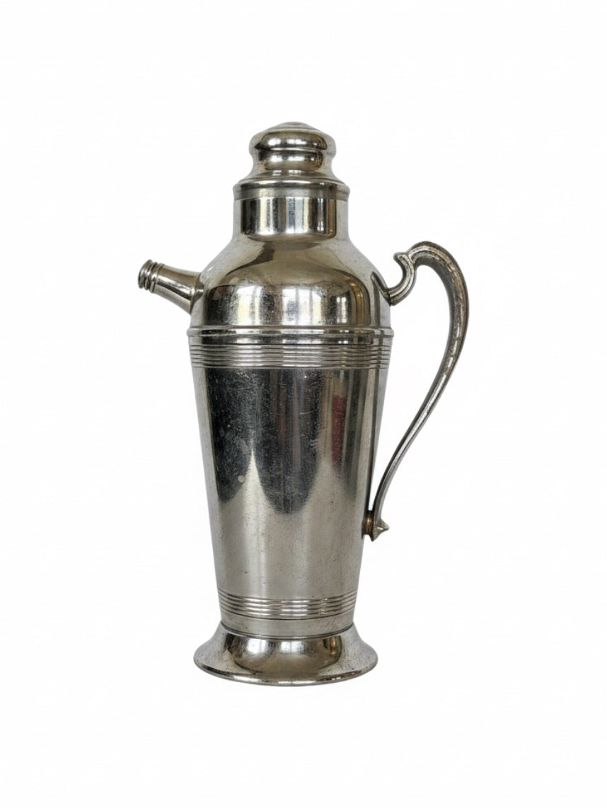Vintage stainless chrome batch cocktail shaker from Embajada Vintage, stylish home decor item with a sleek, reflective finish.