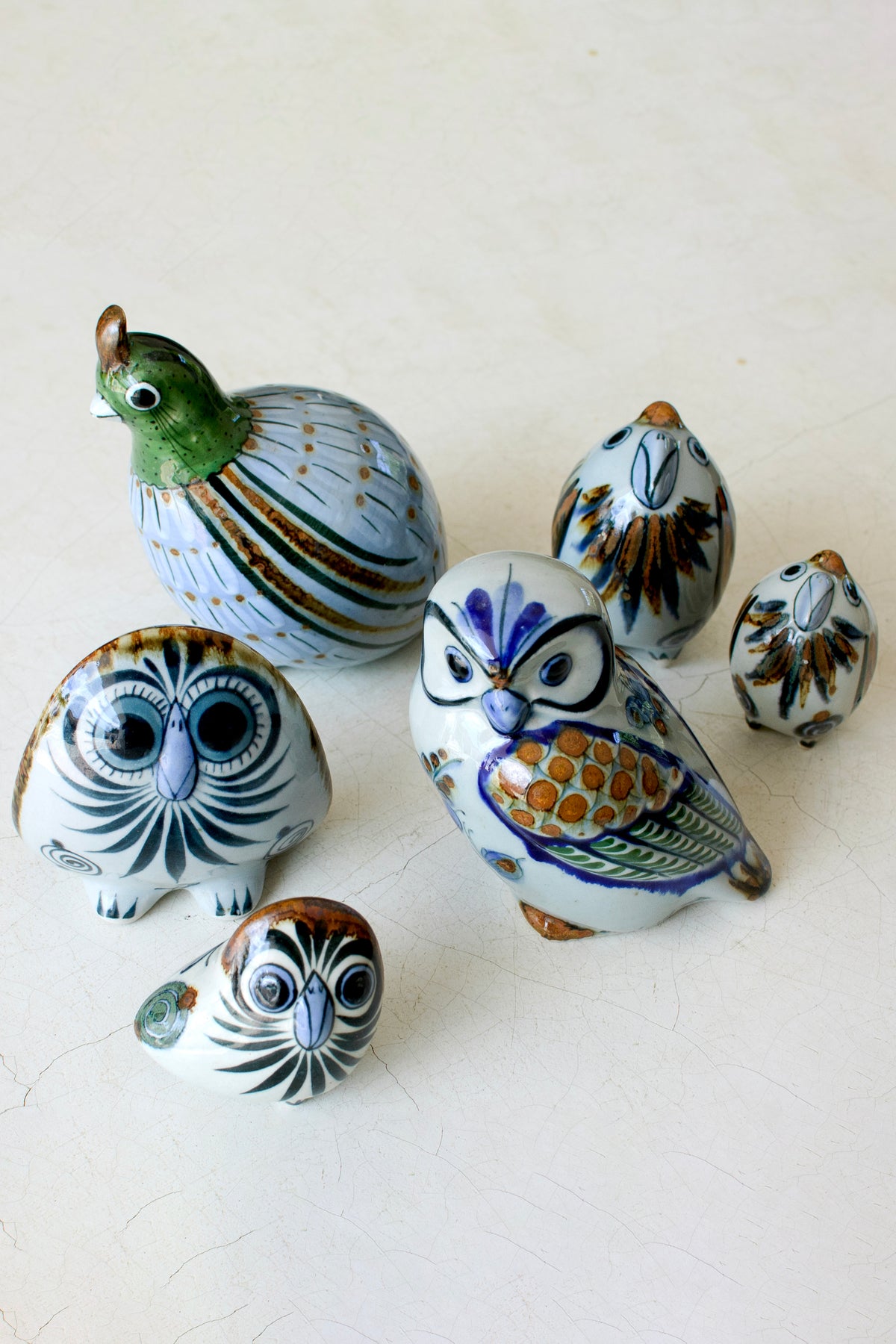 Three-legged owl sculpture from El Palomar home decor collection by Embajada Craft, featuring detailed craftsmanship and natural finish.