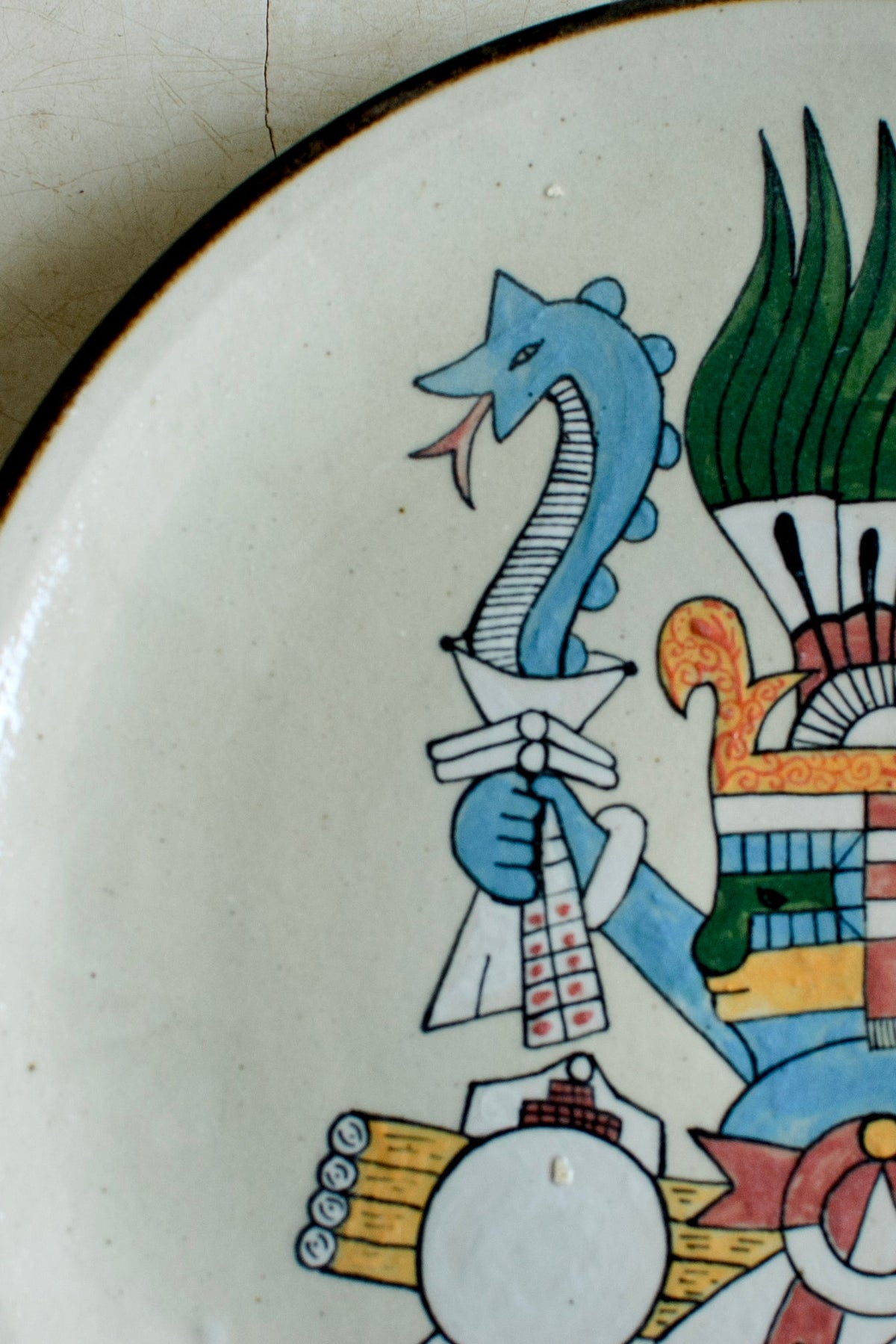 Pre-Hispanic figure plate by Embajada Craft, traditional El Palomar tableware with intricate Aztec-style design.