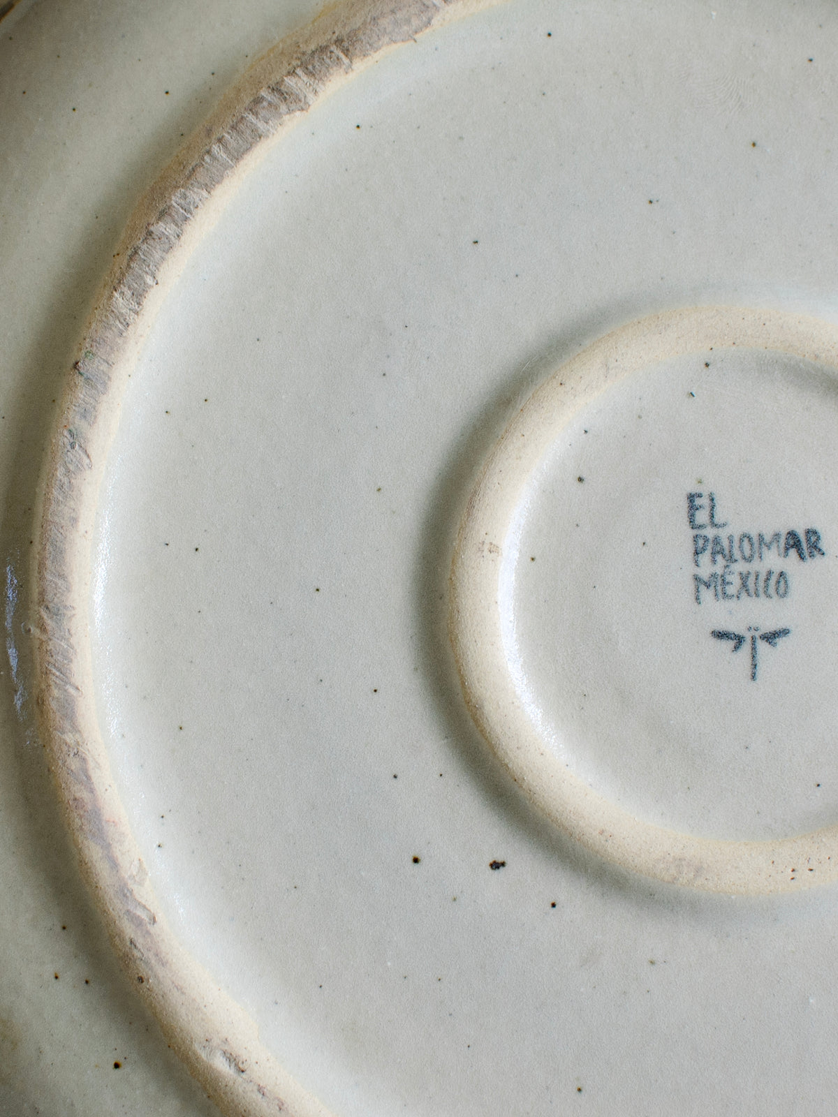 Pre-Hispanic figure plate by Embajada Craft, traditional El Palomar tableware with intricate Aztec-style design and craftsmanship.