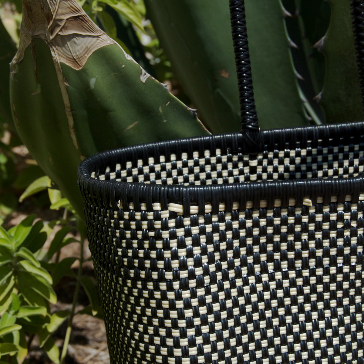Close-up of the Tlacochahuaya Lake Bag by La Embajada, showing detailed woven patterns and natural leather accents.