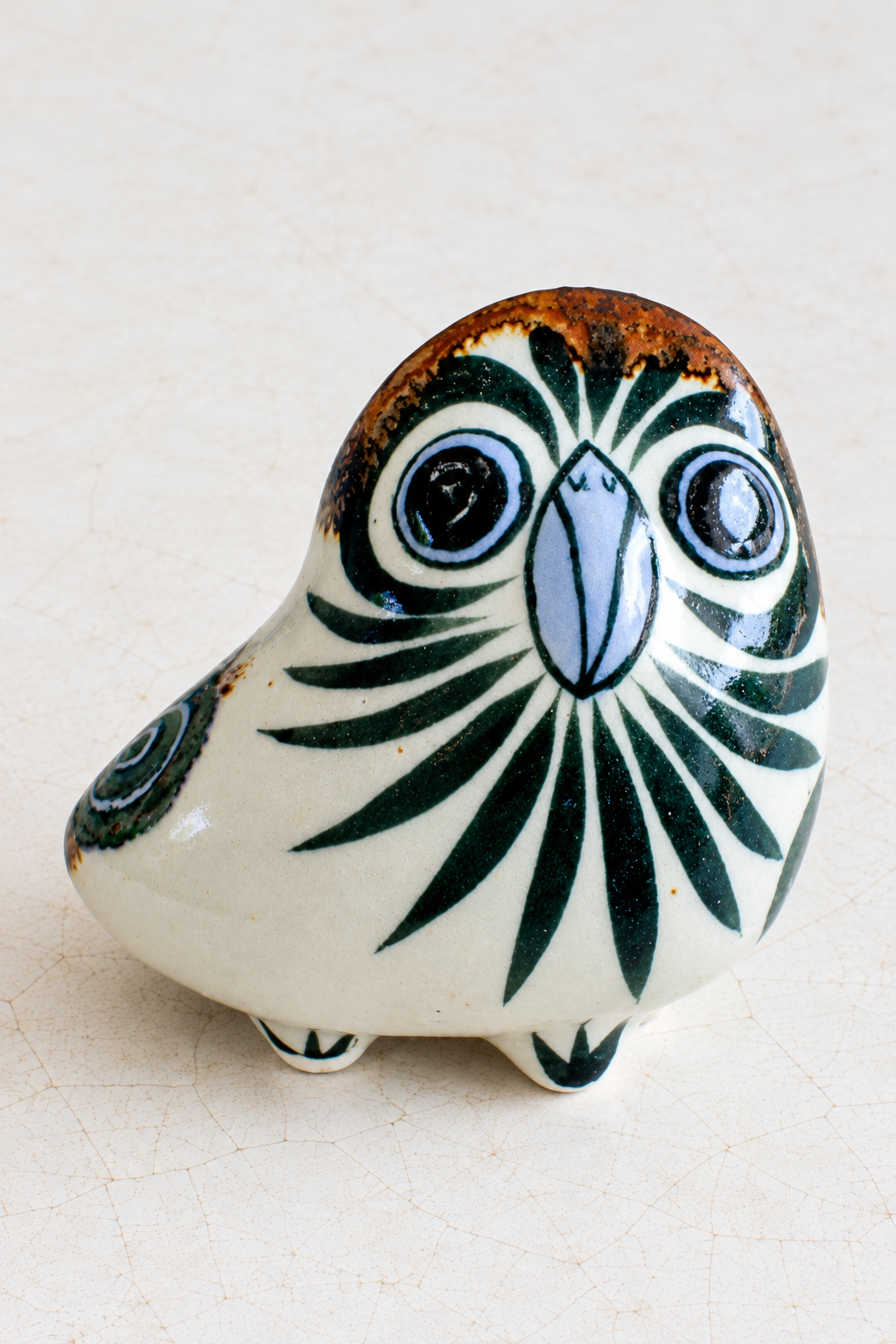 Whimsical crackle-glazed three-legged owl figurine by Embajada Craft, perfect for unique home decor displays.