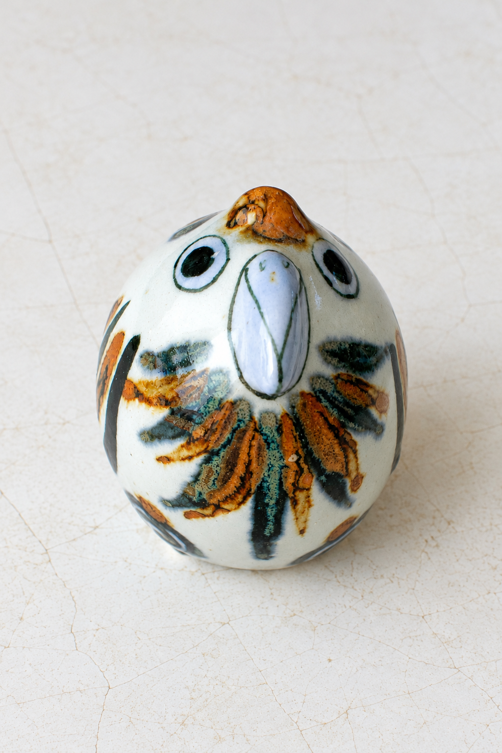 Hand-painted ceramic parrot figurine from Embajada Craft, whimsical home decor bird with colorful details.