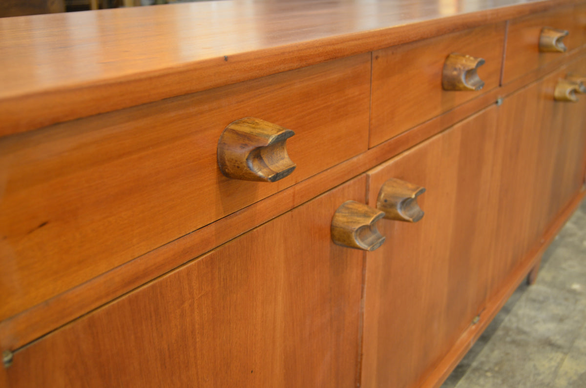 Long Mexican Mid-Century Wood Credenza by Embajada Vintage, showcasing sleek wooden furniture with mid-century design details.