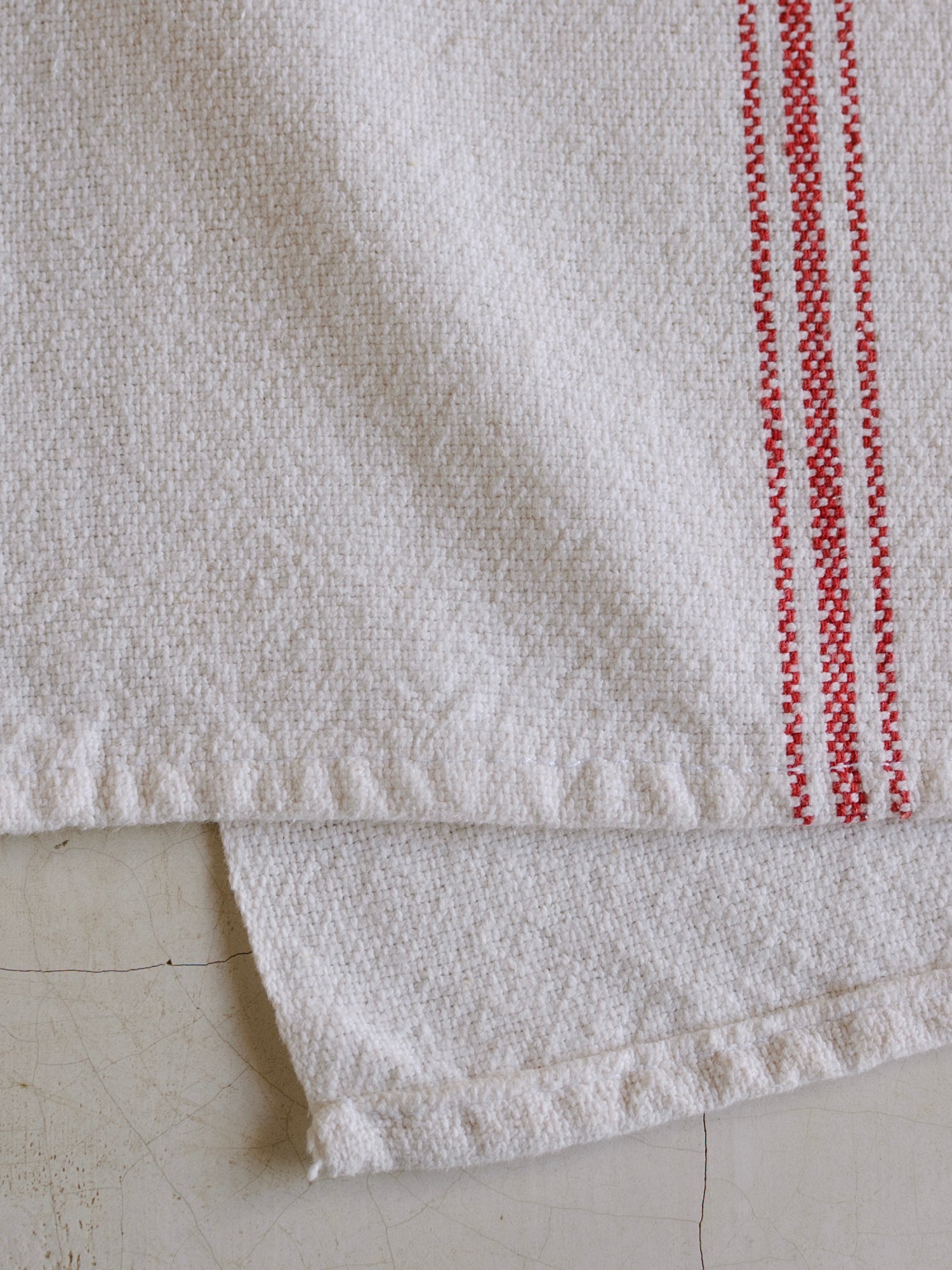 Oax-i-fornia Ex-Hacienda Guadalupe Tejate cotton table runner with colorful woven design on a dining table.