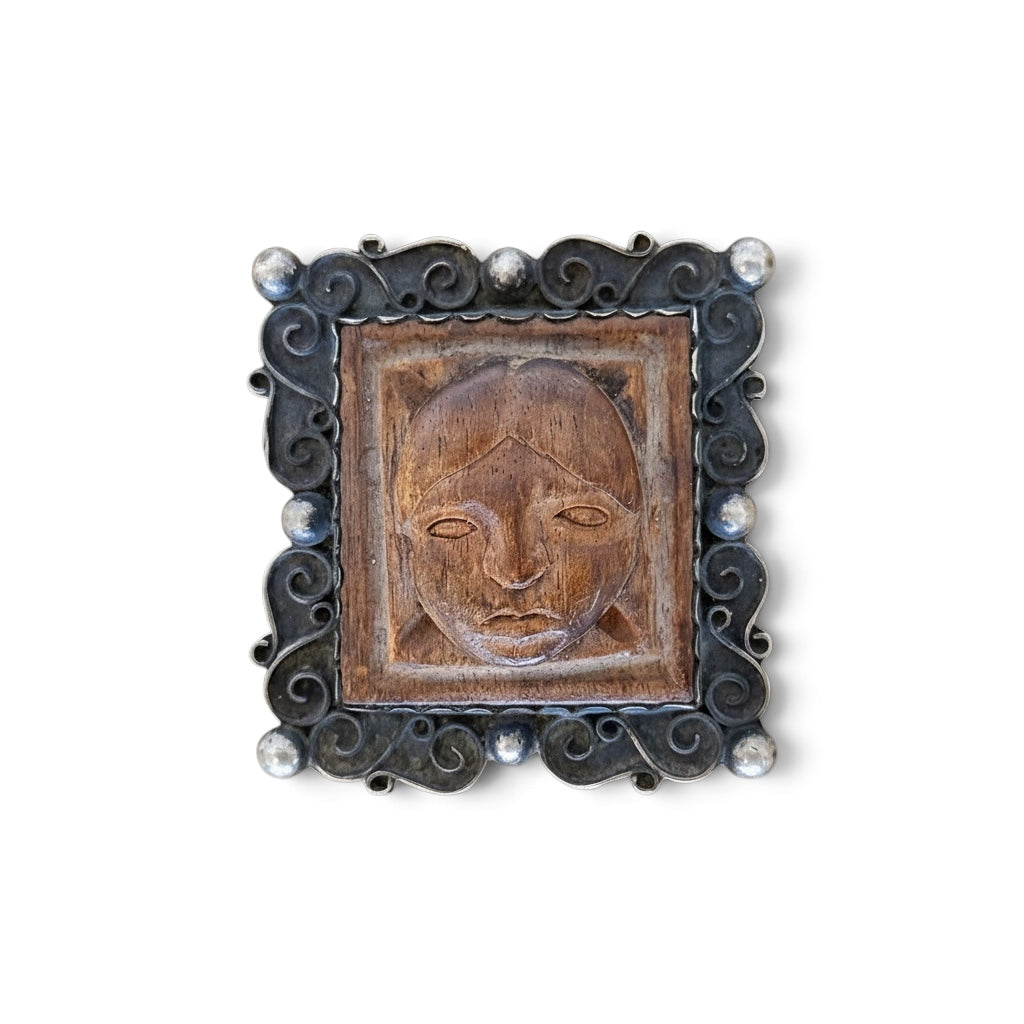 Wood and silver portrait brooch from the 1950s, vintage Taxco jewelry featuring detailed craftsmanship and classic design.