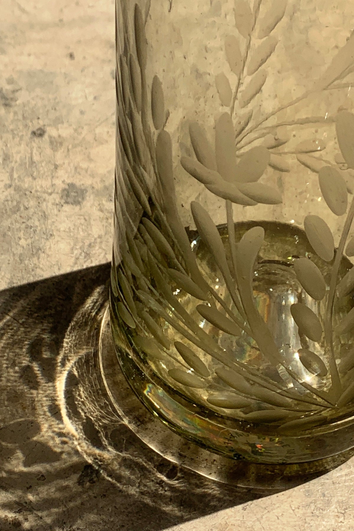 Hand blown glass bottle with pepita engraving, decorative home decor piece by Embajada Craft, featuring intricate glasswork and design.