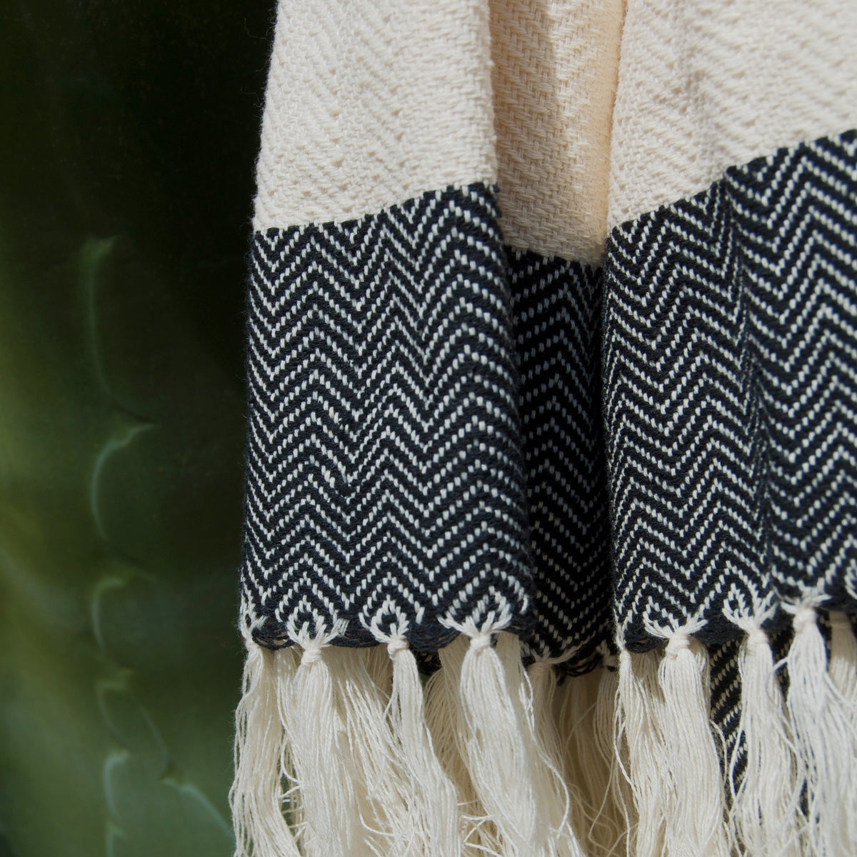 Close-up of La Embajada Susurros Beach Towel with soft, textured fabric in neutral tones, perfect for beach or poolside lounging.