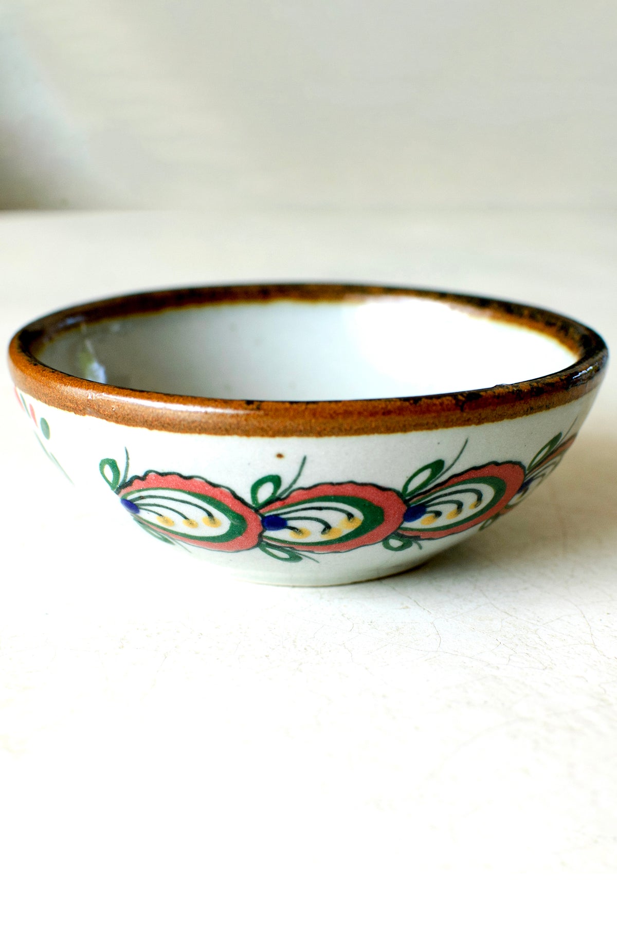 Colorful exterior-painted dessert bowl by Embajada Craft, showcasing vibrant tableware design and craftsmanship.