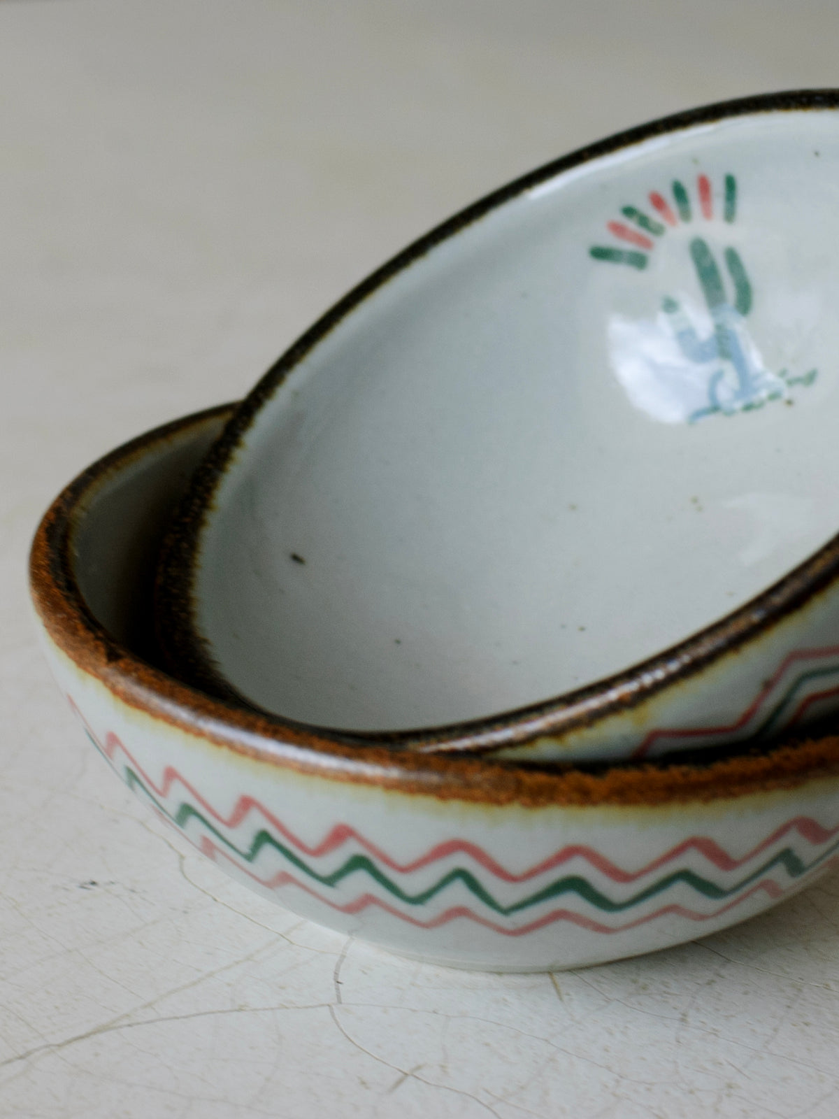 Stacked El Palomar Cactus Dessert Bowls from Embajada Craft, featuring vibrant cactus designs on colorful tableware.