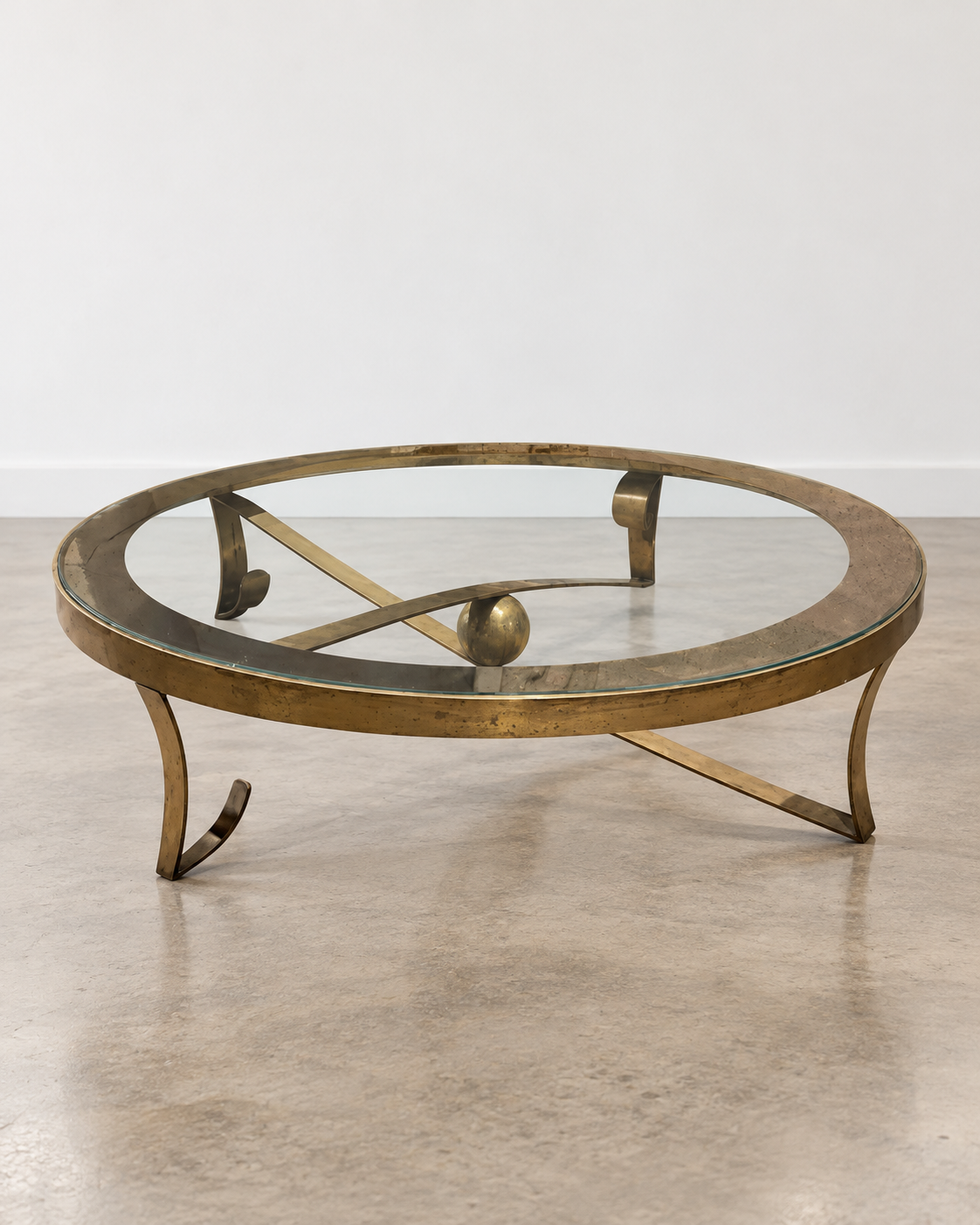 Bronze ball cocktail table from the 1950s with patinated bronze finish and glass top, vintage furniture piece by Embajada Vintage.