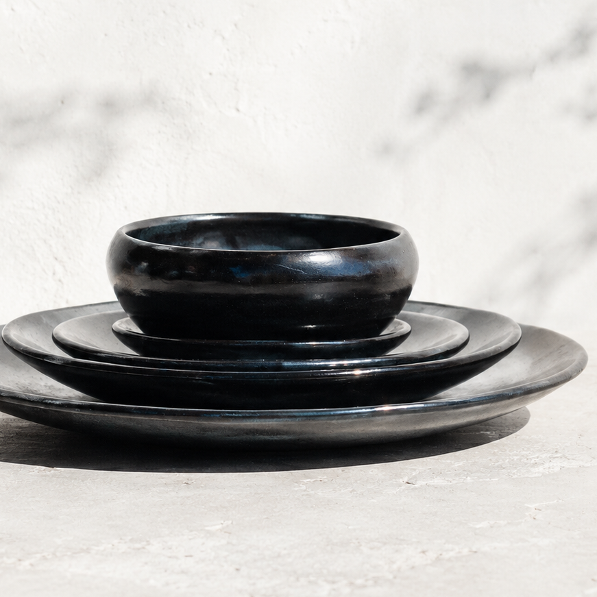 Set of black ceramic bowls on a marble surface